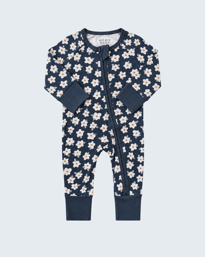 Navy ribbed bamboo romper with white daisy print, long sleeves, front zipper