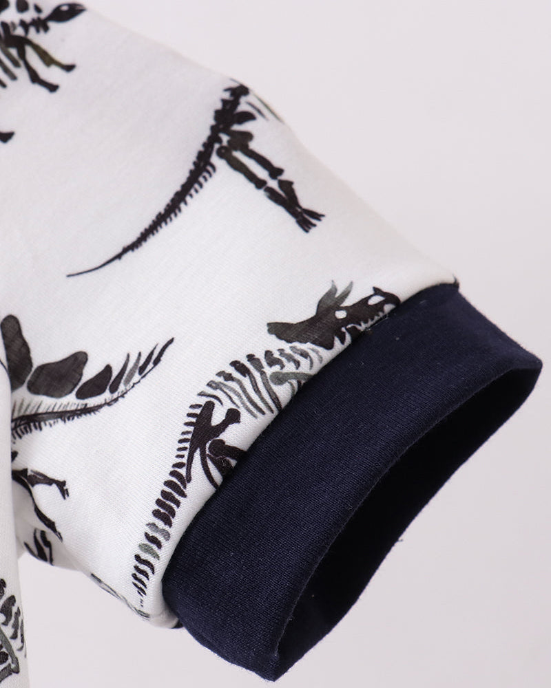 Close-up of a white fabric with black patterns and a navy border on a light gray background