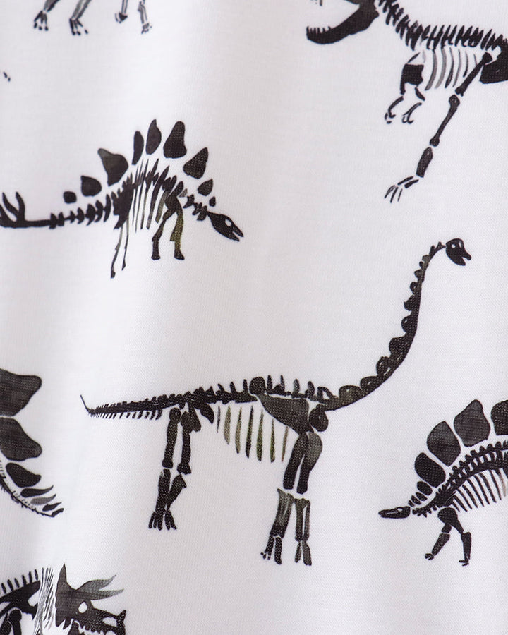 Pattern of black dinosaur skeletons on a white background