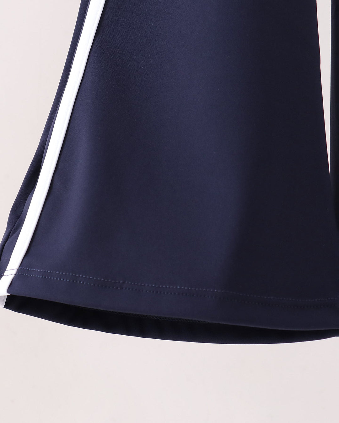Navy flare active pants with white side stripe detail at hem