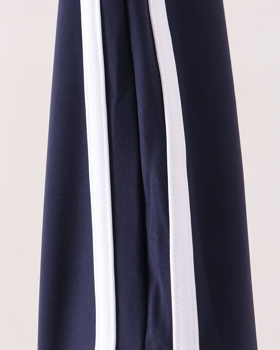 Navy active pants with vertical double white stripe along side seam