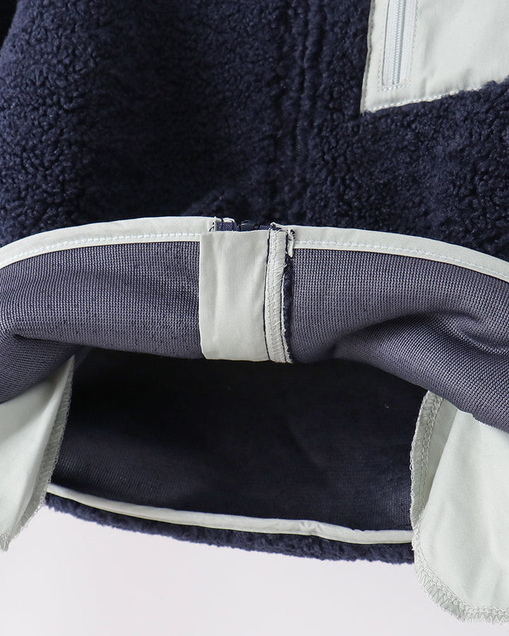 Navy fleece jacket hem with contrast lining and interior zipper opening