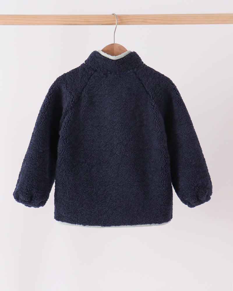 Navy fleece zip jacket back view with stand collar and rounded hem