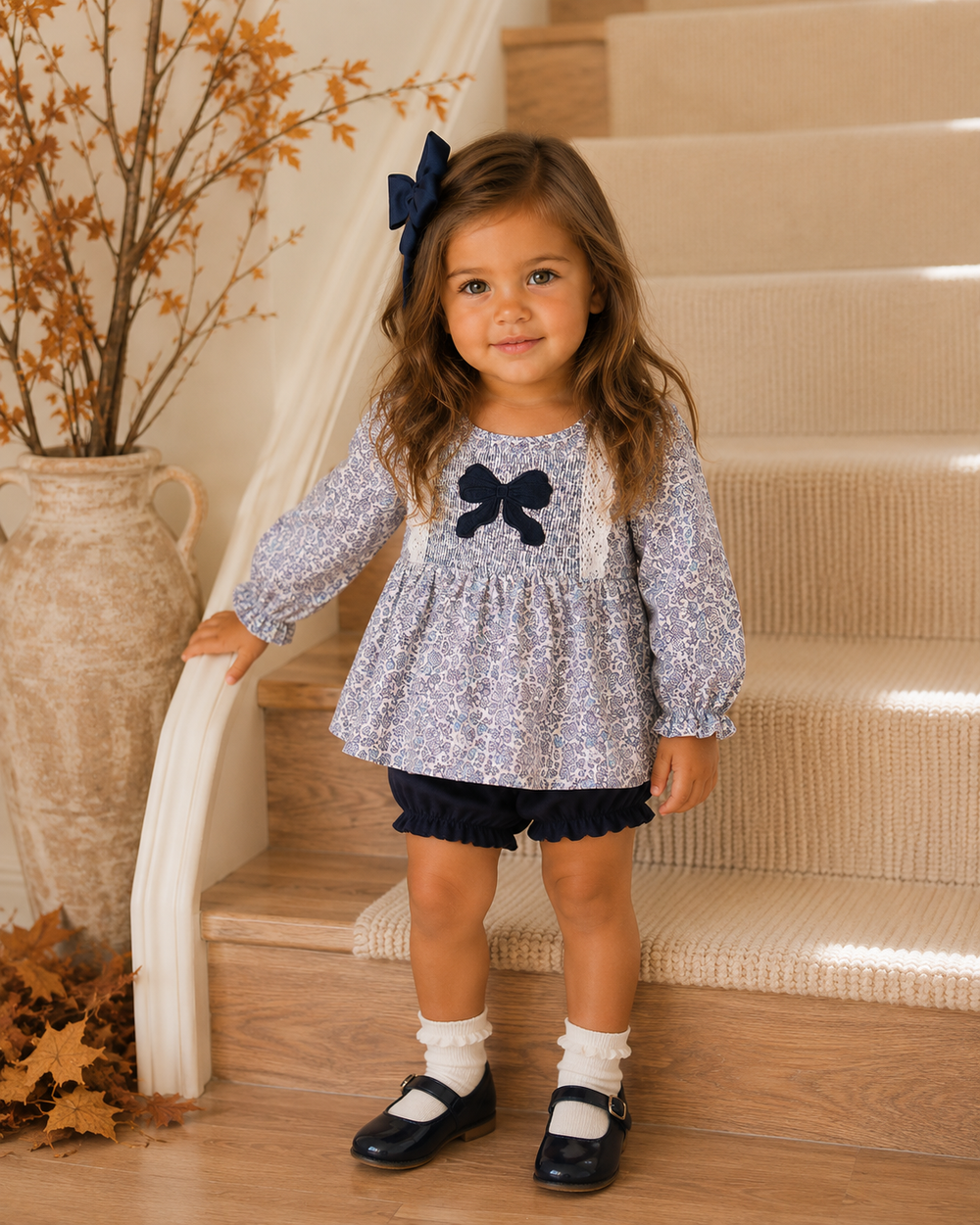 Toddler girl standing by the stairs