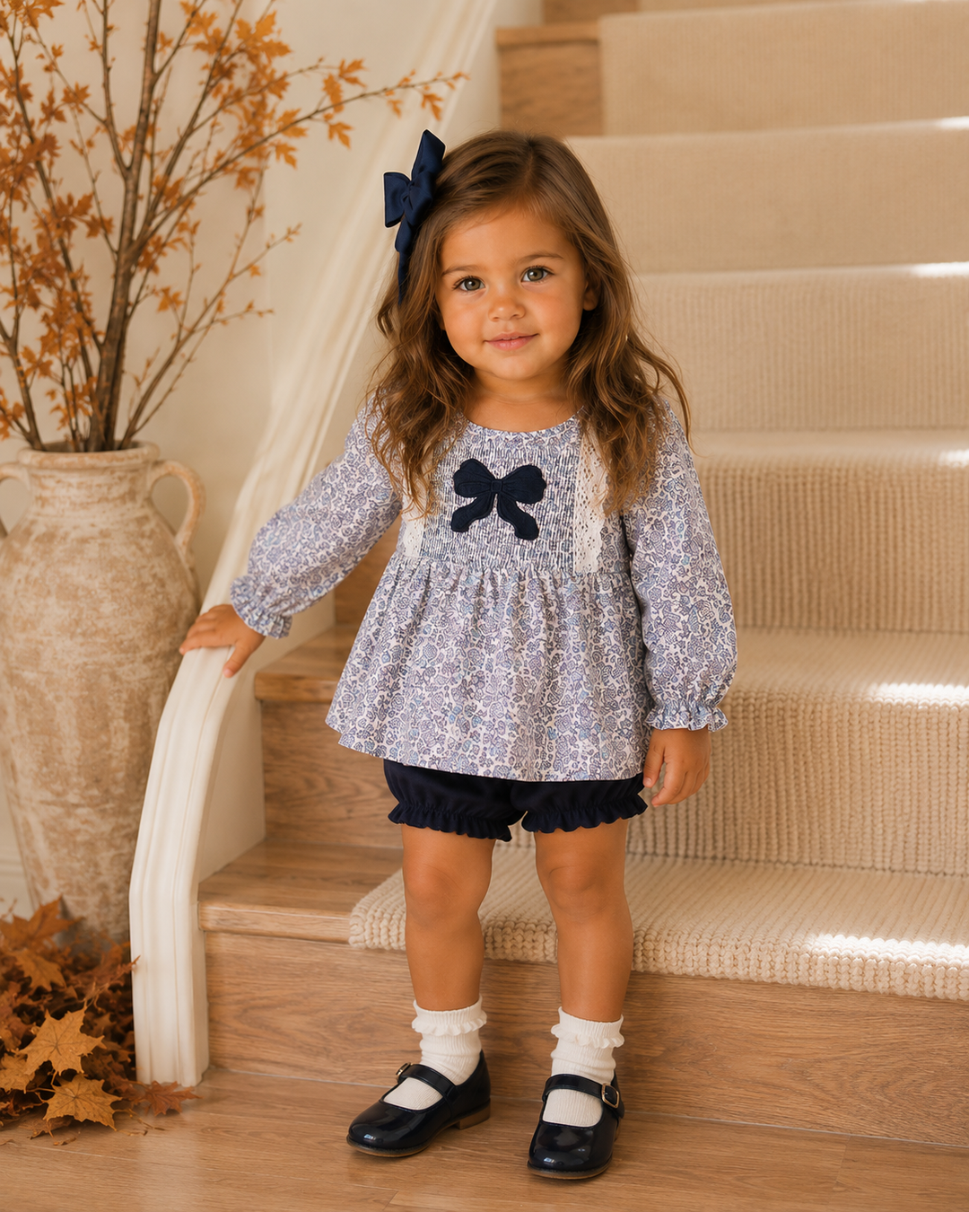 Toddler girl standing by the stairs
