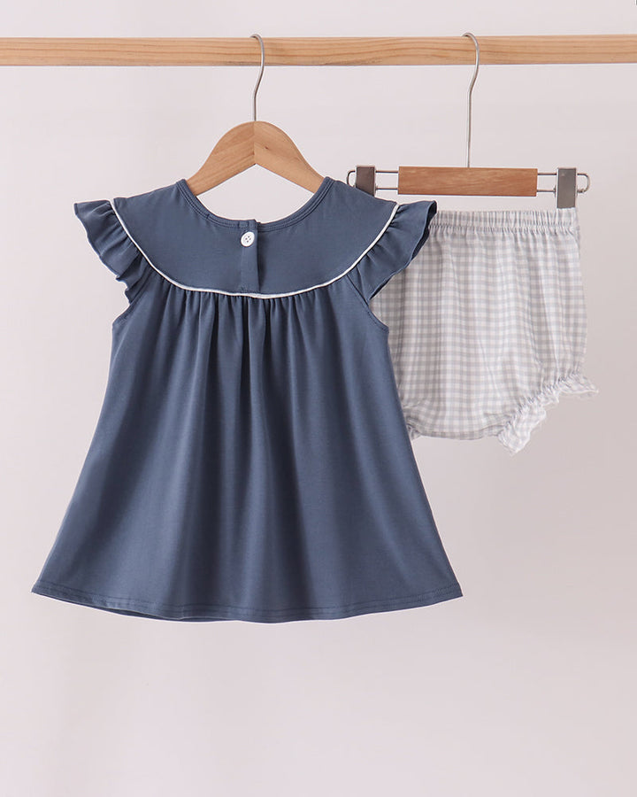 Navy dress with ruffle collar and white gingham bloomer set on hangers