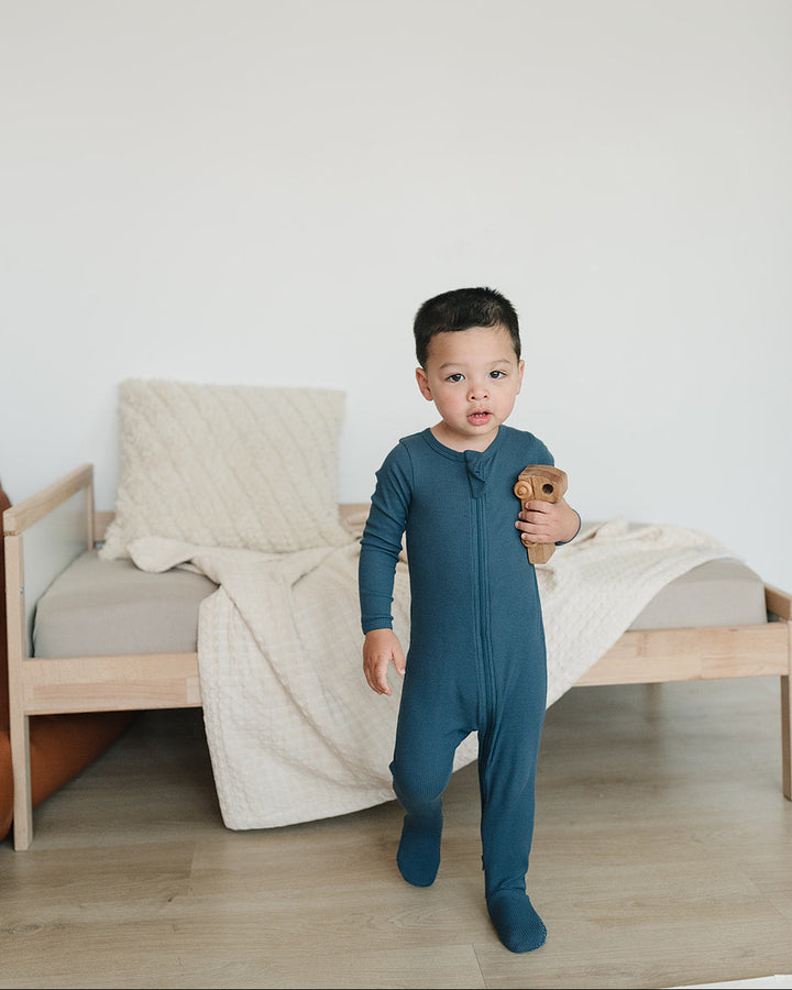 Dark blue ribbed zip-front footed onesie, long sleeves; full-body on child