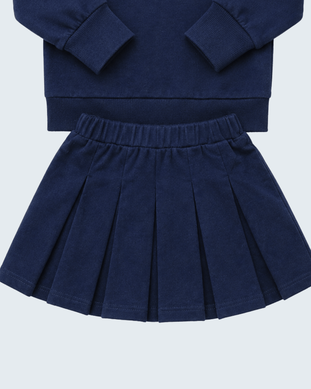 Navy pleated skirt with elastic waistband paired with matching navy long-sleeve top
