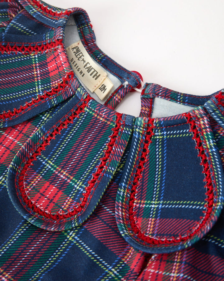 Plaid dress neckline closeup with petal collar, trim stitching, and size tag