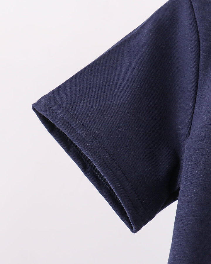 Navy blue sleeve of a shirt on a light gray background