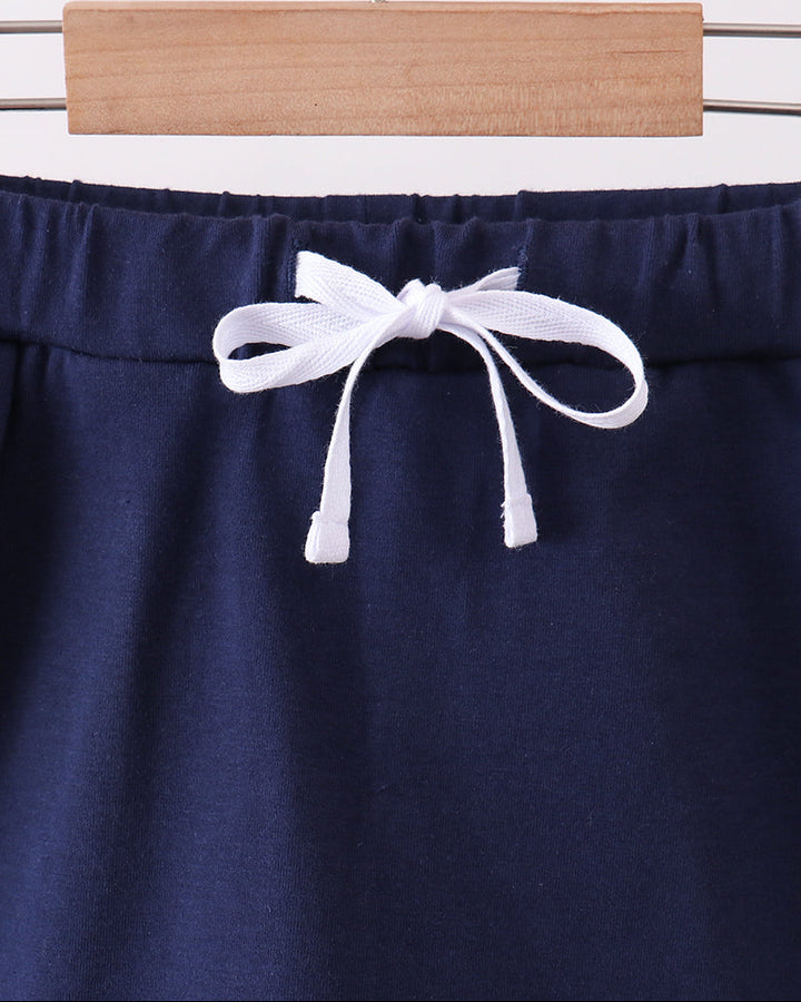 Navy bow skort with elastic waistband and white ribbon ties