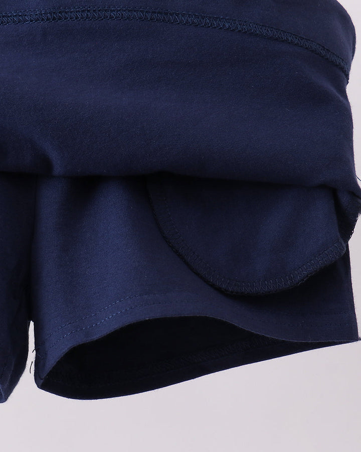Navy skort back with scalloped hem and black underlayer