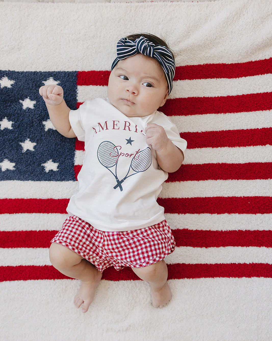 Navy and white striped head wrap with knotted bow worn on baby’s head
