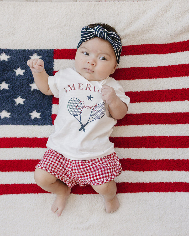 Navy and white striped head wrap with knotted bow worn on baby’s head