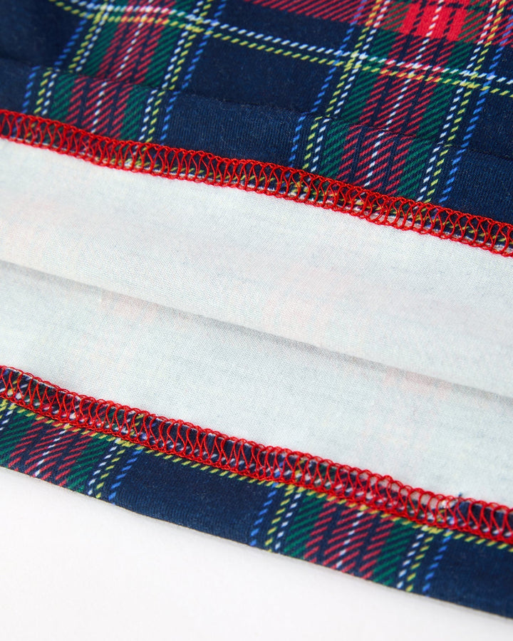 Plaid dress hem with red topstitching and gathered tier detail