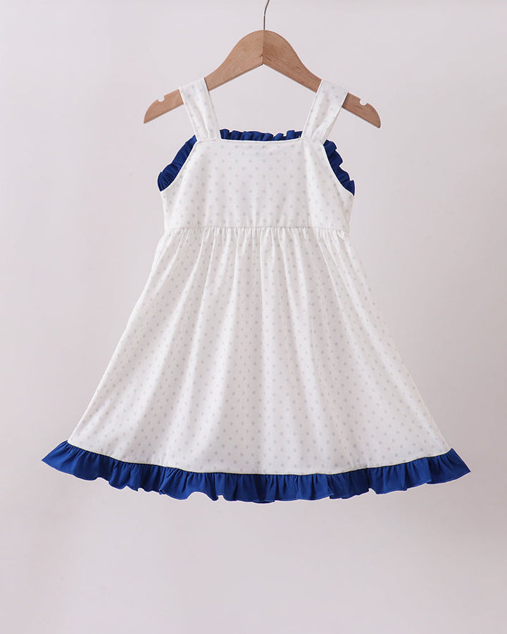 White dress with blue trim on a hanger against a white background