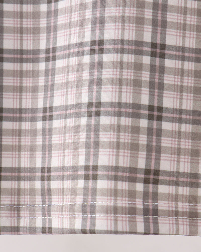 A close-up of a plaid fabric pattern with intersecting gray, white, and thin pink stripes, showing a stitched hem along the bottom edge.