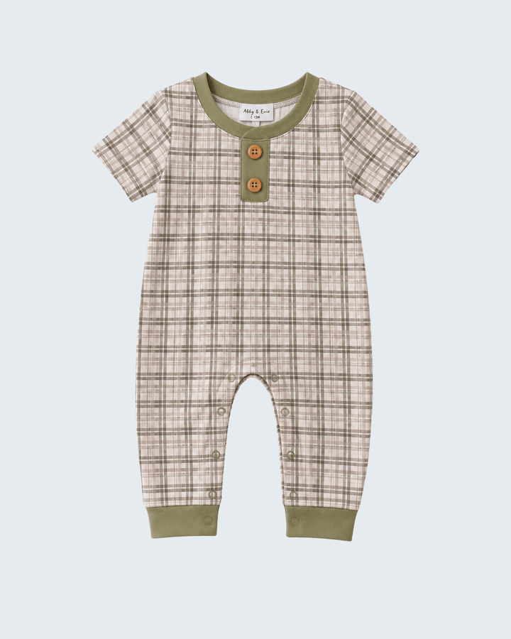 A baby short-sleeve romper in a beige and brown plaid pattern with olive green trim at the collar, cuffs, and hem, featuring two decorative wooden buttons on the chest.