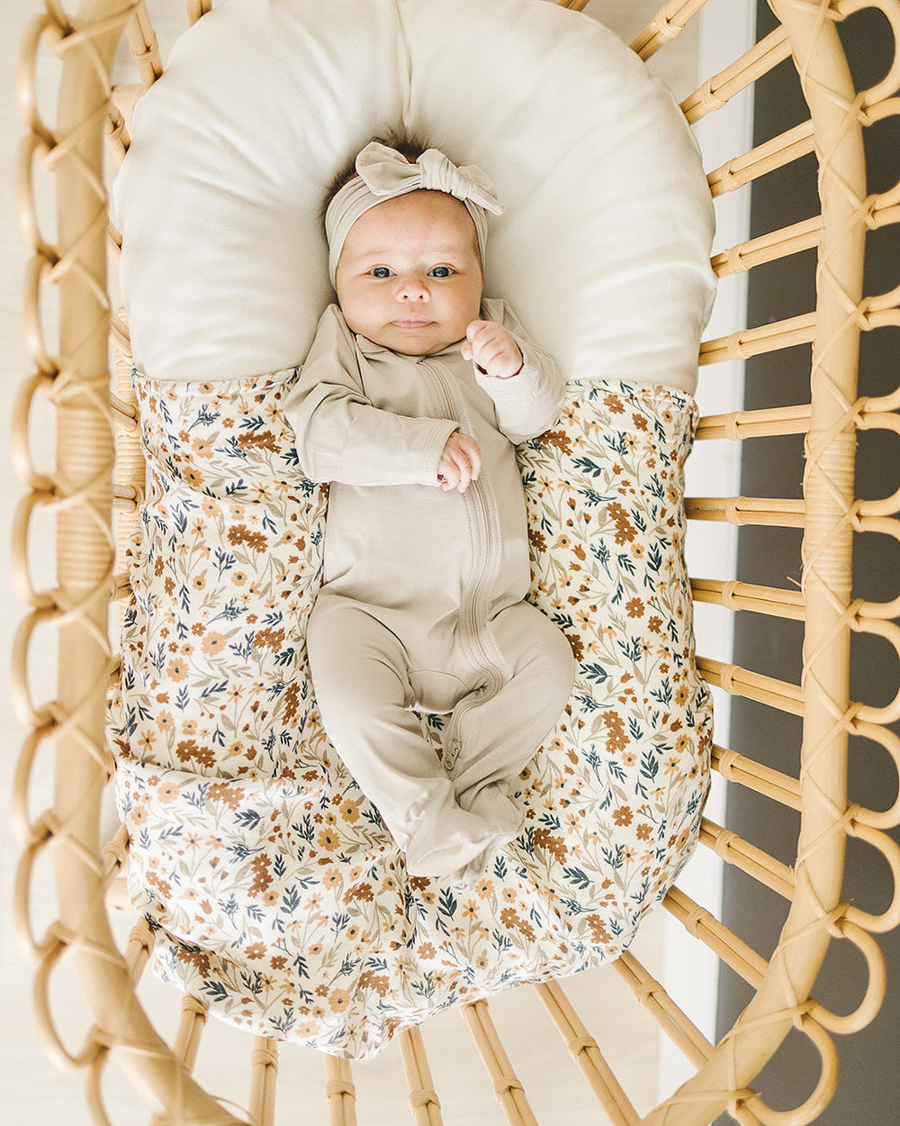 Light beige footed zipper romper with front zip, long sleeves