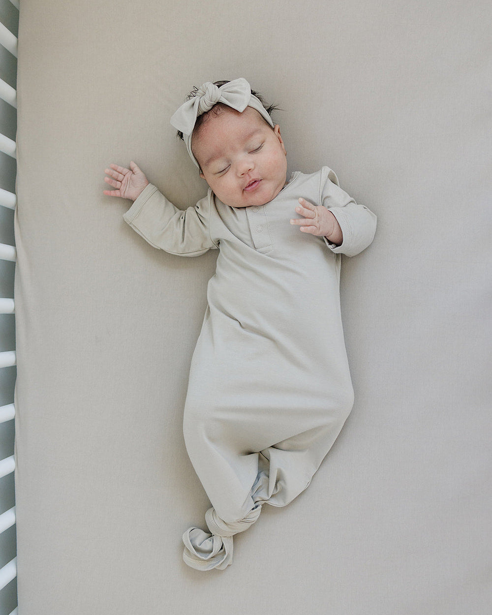 Light beige baby head wrap bow knot, wrapped snugly around the head.