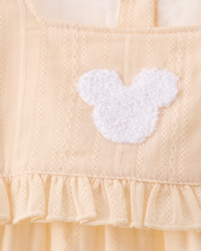 Cream bodice with white textured heart applique and gathered ruffle hem