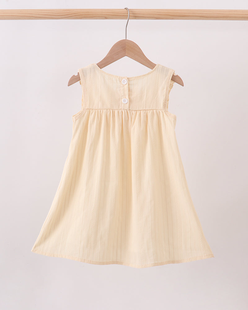 Cream sleeveless dress with button placket and gathered yoke ruffles