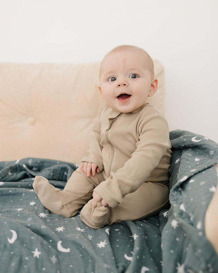 Ribbed cotton zipper romper on infant, front zip with long sleeves and footed legs