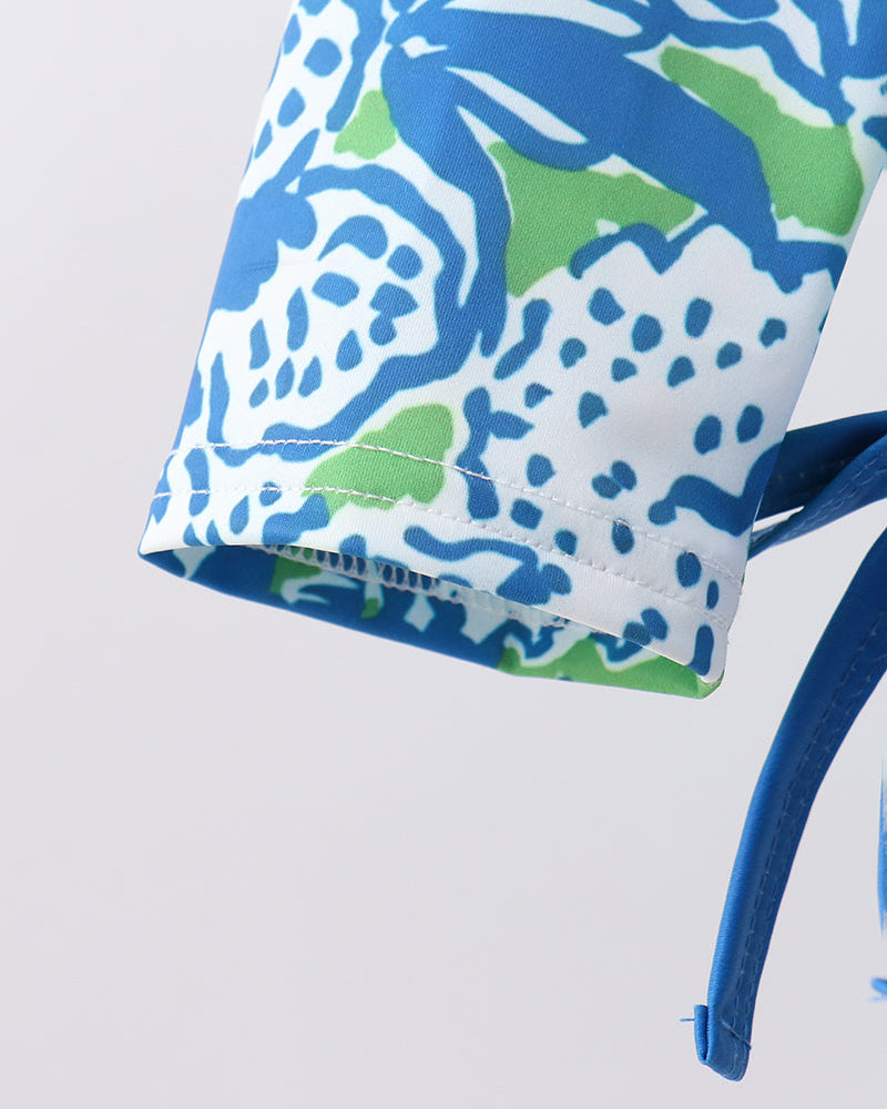 Close-up of a blue and green patterned fabric with a white background