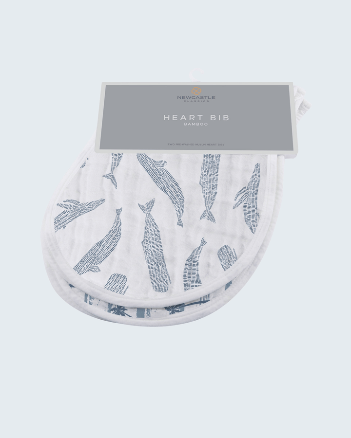 Heart-shaped bib with whale pattern and packaging on a white background