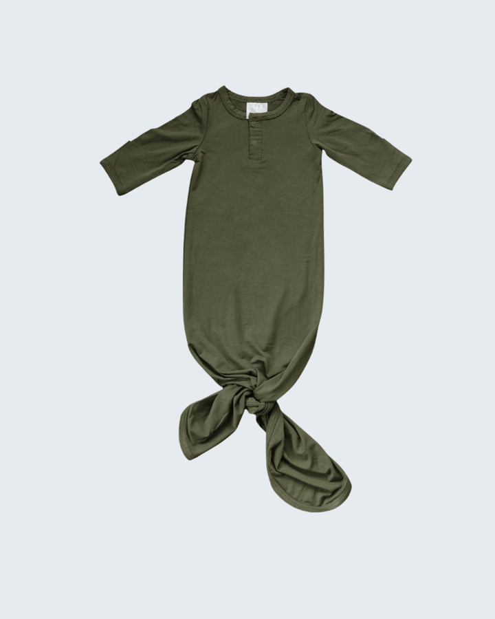 Green baby gown with a knot on a white background