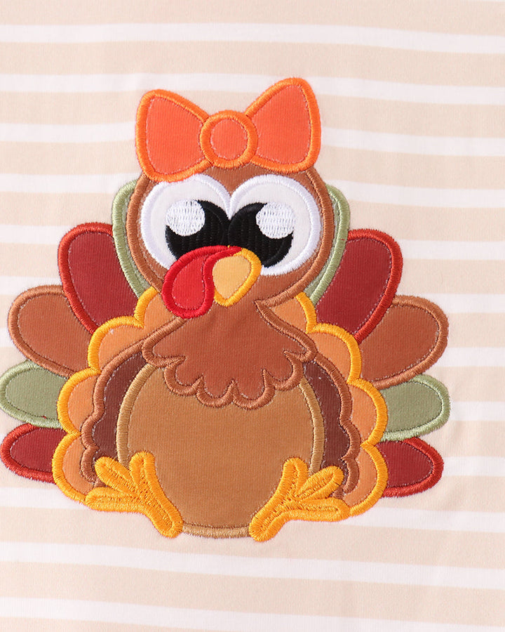 Turkey applique with bow on striped shirt, orange and brown felt details