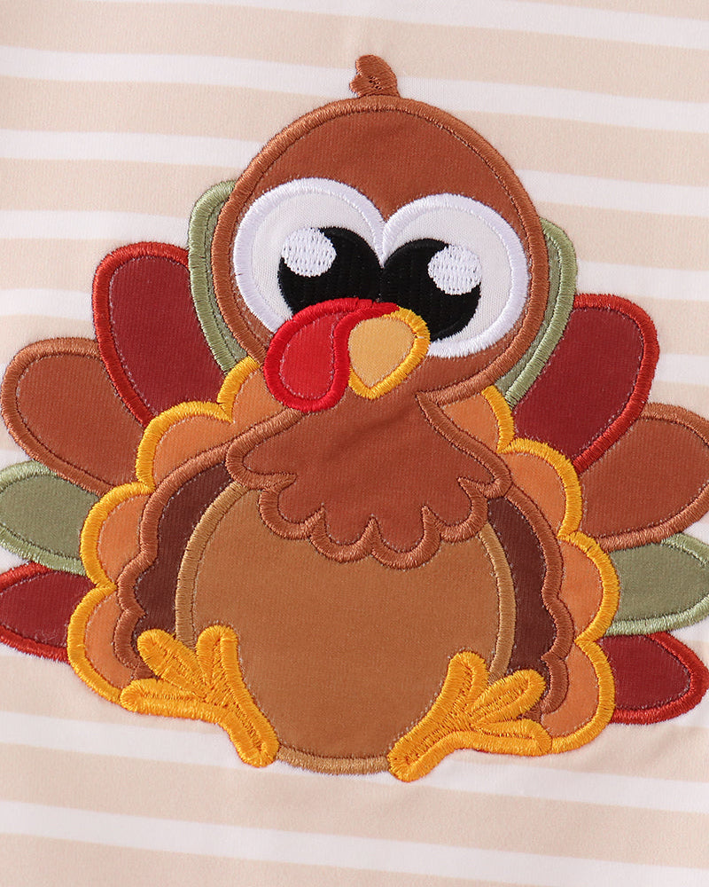 Turkey applique patch with layered felt feathers on striped romper front