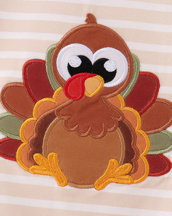 Turkey applique patch with layered felt feathers on striped romper front