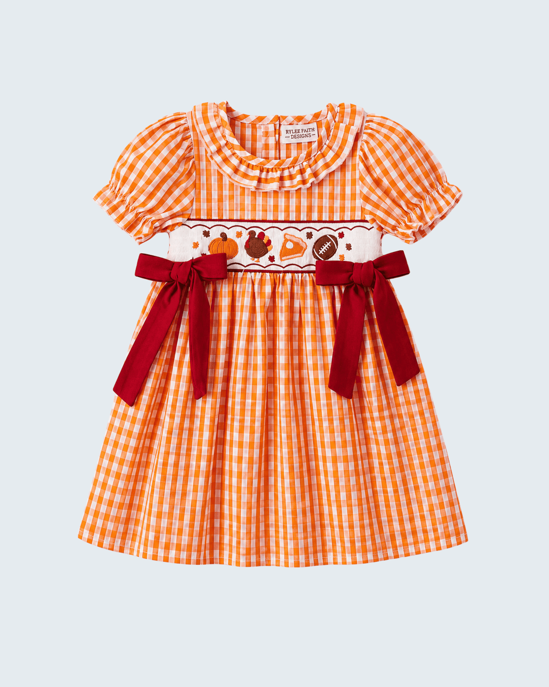 Orange gingham embroidered dress front with ruffled collar, puff sleeves, red ribbon bows