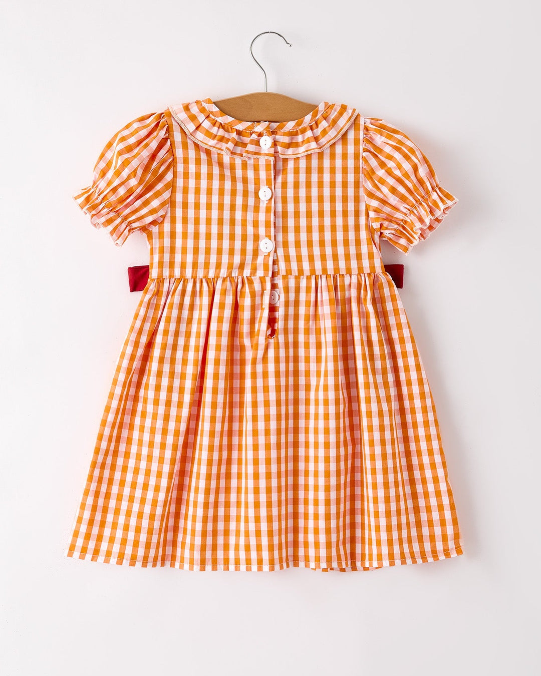 Girls orange checkered dress with puff sleeves, ruffled collar, and front buttons