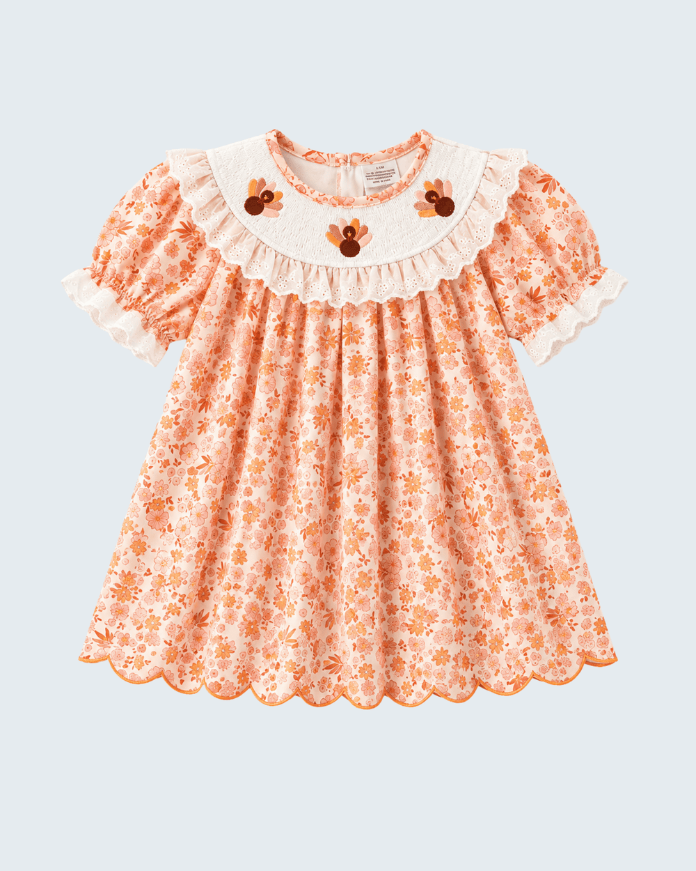 Orange floral lace dress with short puff sleeves and white ruffled yoke