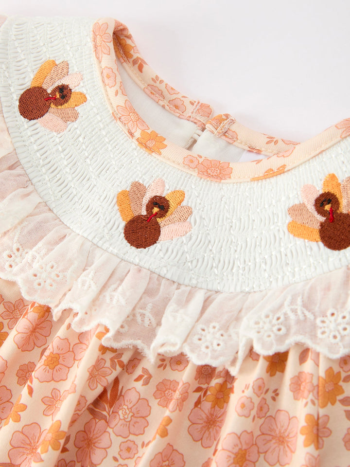 White lace ruffle neckline and orange floral baby romper bodice