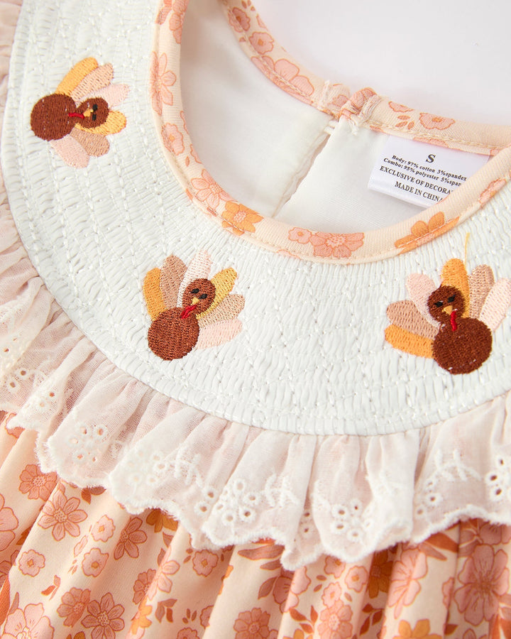 Orange floral lace dress close-up: white yoke with embroidered flower details