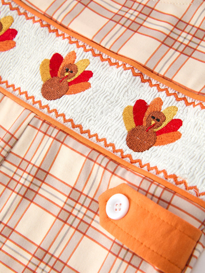 Orange plaid baby jon jon with smocked turkey embroidery and button detail
