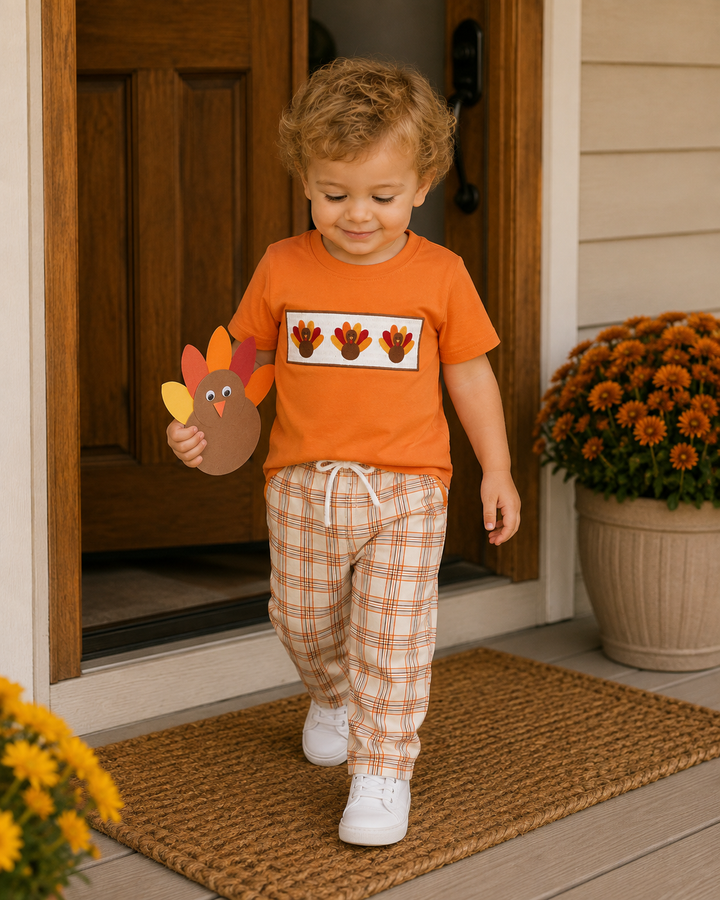 Kids orange T-shirt and plaid pants set, worn with white sneakers