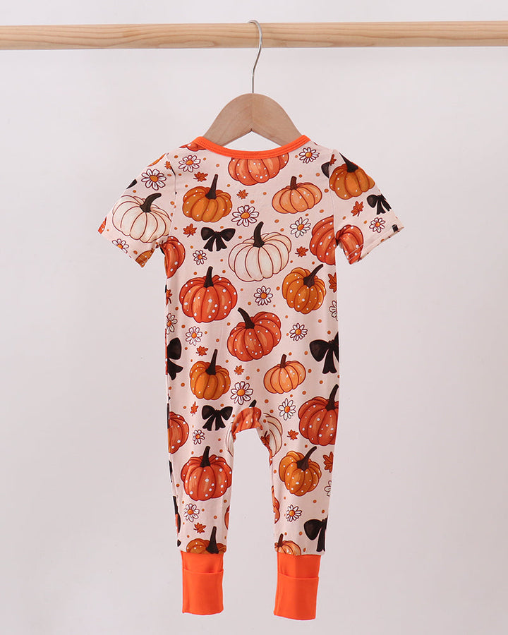 Orange pumpkin floral zip romper with long sleeves and footed legs