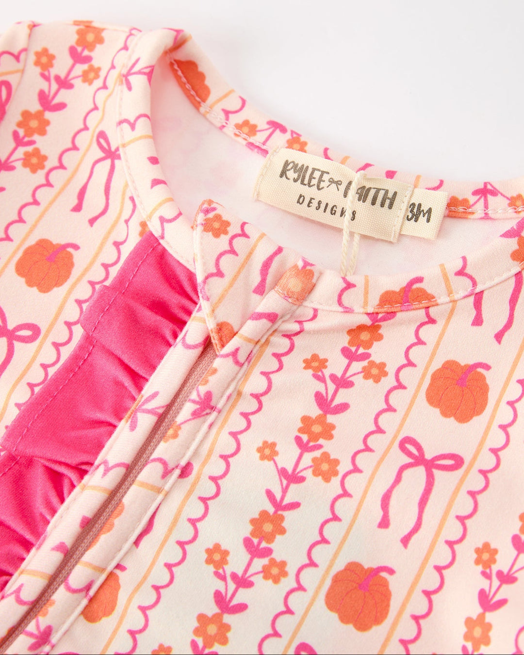 Baby sleeper neckline and button placket with pink graphic pattern