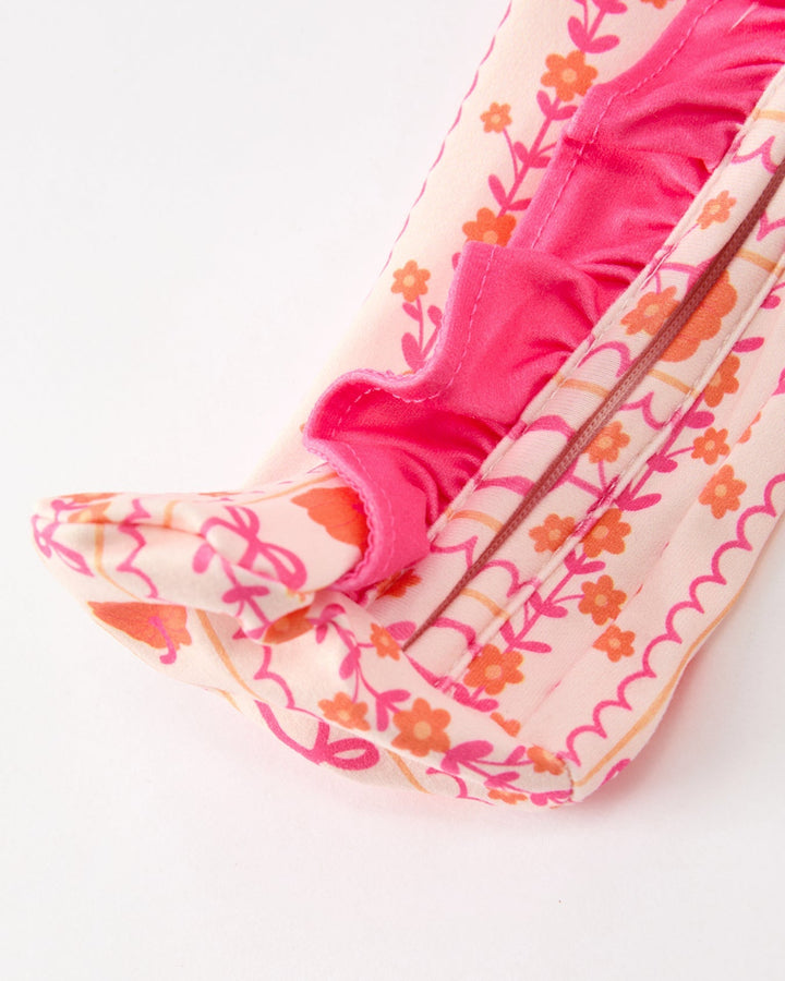 Baby sleeper footed cuffs with pink and cream patterned fabric and satin trim