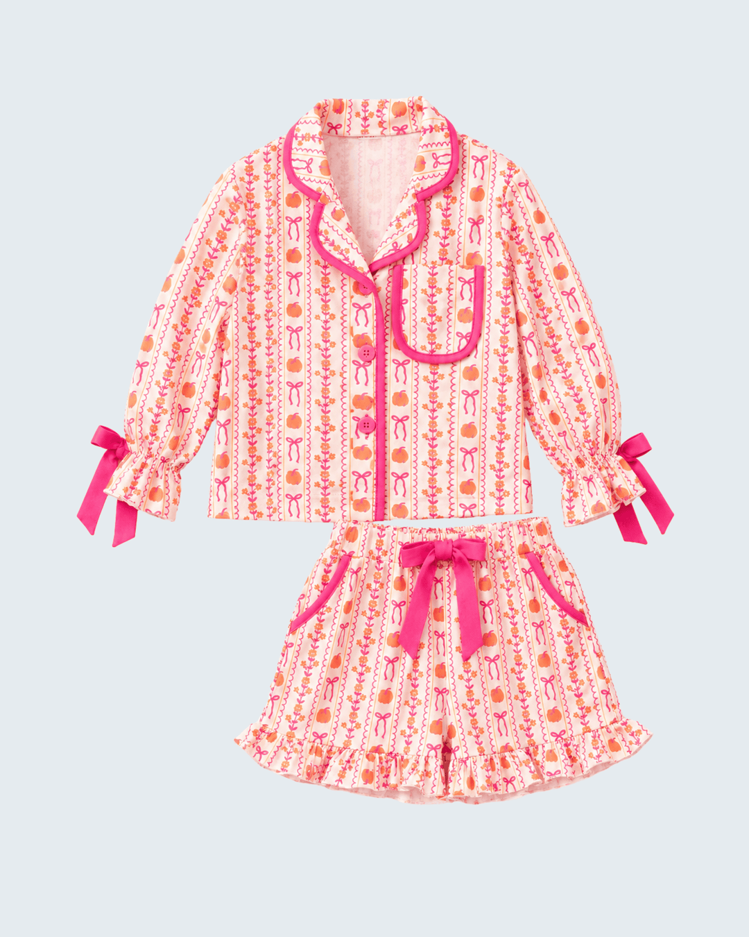 Girls' pink pumpkin bow pajama set with button-front top and ruffled shorts