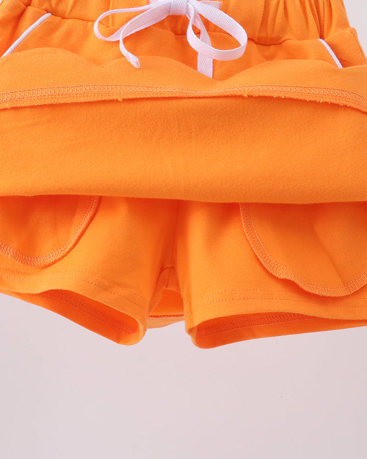 Orange skort with layered front and scalloped hem detail plus bow ties