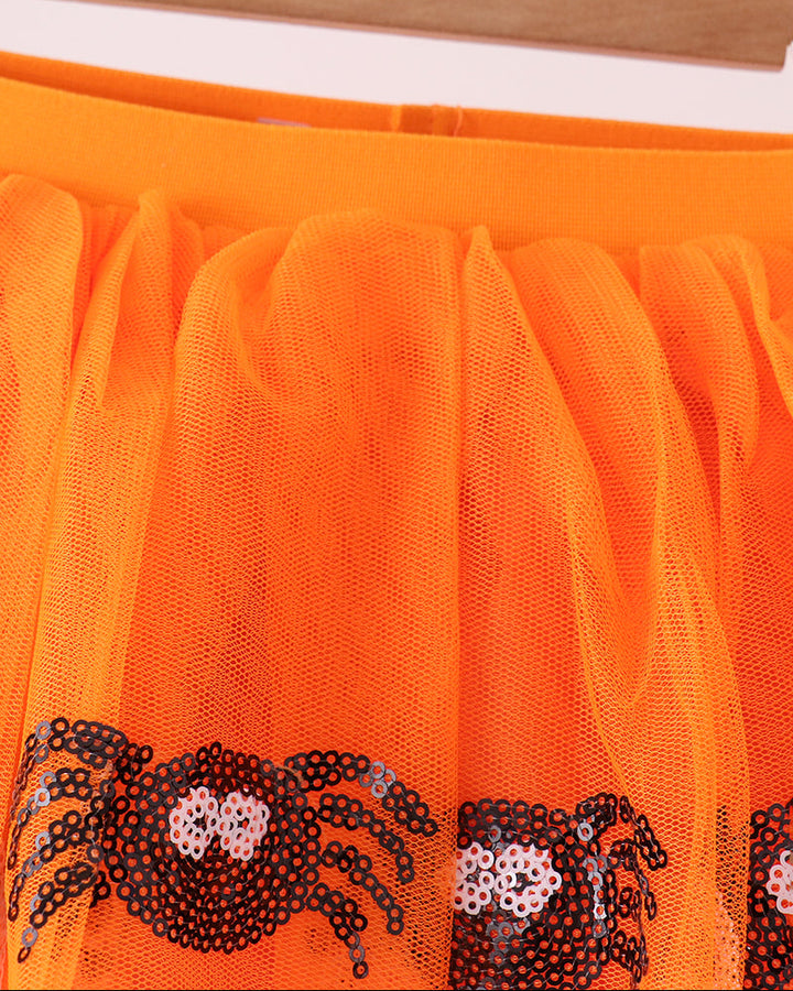 Orange mesh tulle tutu with black-and-silver spider sequin motifs at the hem