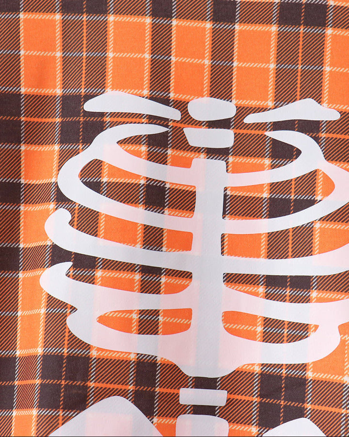 Orange plaid long-sleeve top with large white skeleton ribcage graphic and black neckline
