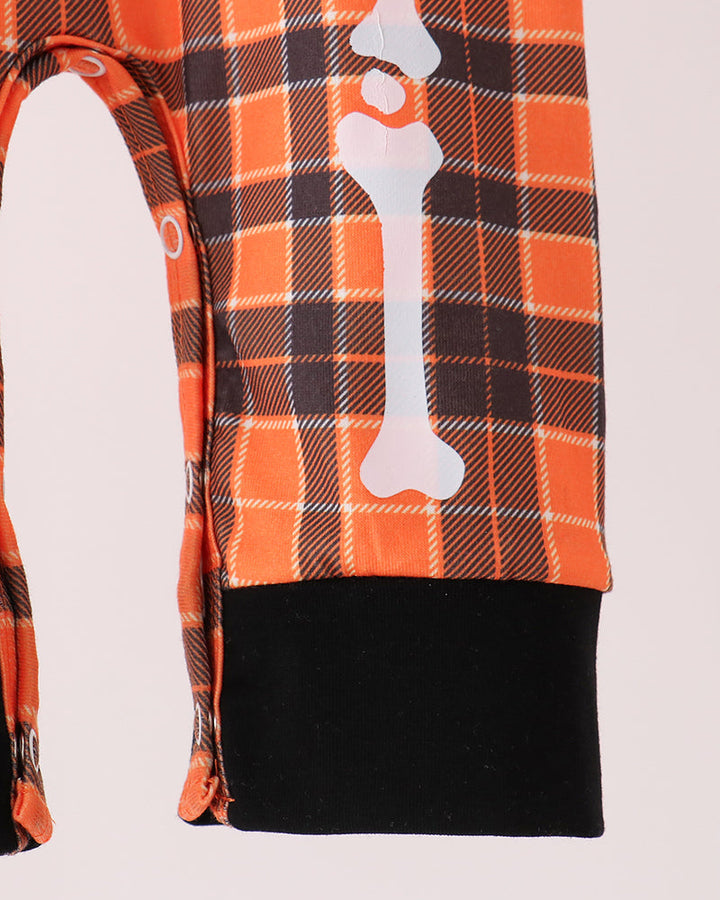 Orange plaid romper with white skeleton print and black foot cuffs