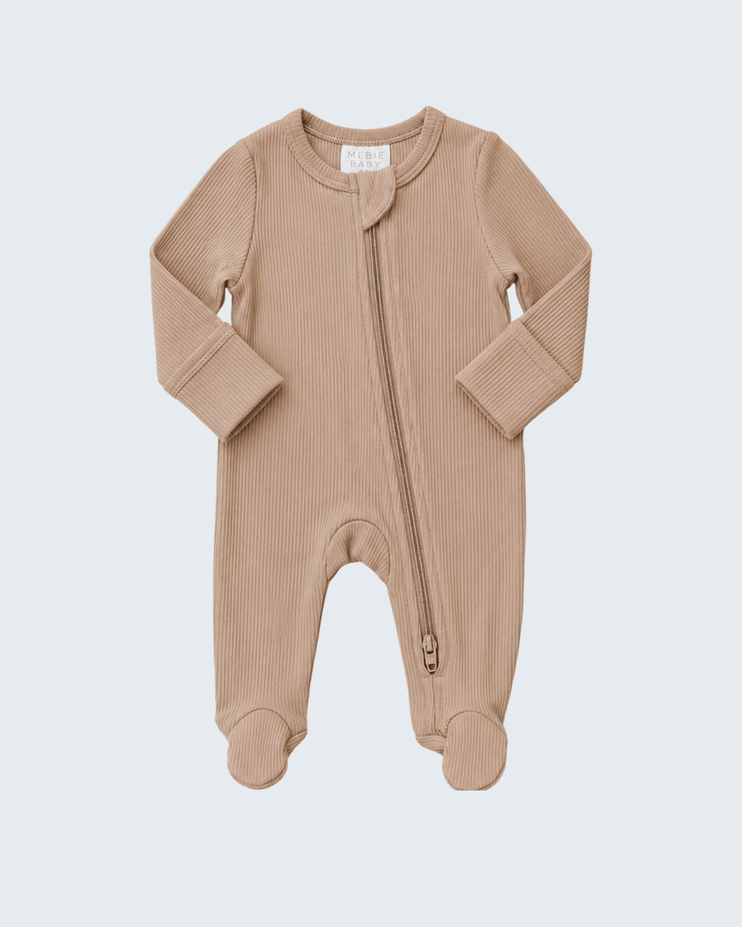 A baby long-sleeve footed sleeper in a warm beige ribbed knit fabric, featuring a front zipper and integrated footies, shown on a light gray background.