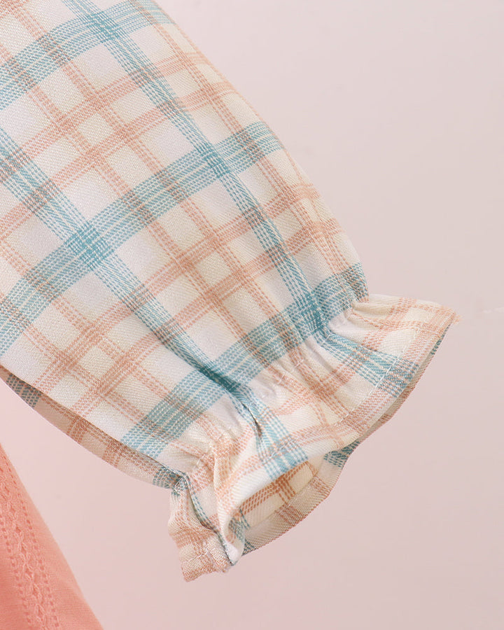 Peach and light blue plaid sleeve cuff with gathered, ruffled edge